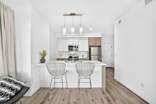 316-205 Spring Creek Common Sw, Calgary, AB - Indoor Photo Showing Kitchen With Stainless Steel Kitchen With Upgraded Kitchen