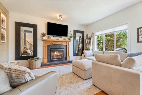 7 Crystal Green Way, Okotoks, AB - Indoor Photo Showing Living Room With Fireplace