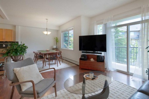 1222-211 Aspen Stone Boulevard Sw, Calgary, AB - Indoor Photo Showing Living Room