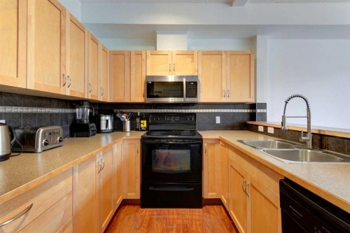 1222-211 Aspen Stone Boulevard Sw, Calgary, AB - Indoor Photo Showing Kitchen With Double Sink