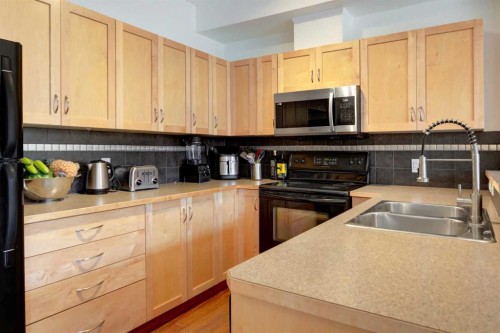 1222-211 Aspen Stone Boulevard Sw, Calgary, AB - Indoor Photo Showing Kitchen With Double Sink