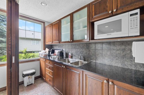 220-8 Prestwick Pond Terrace Se, Calgary, AB - Indoor Photo Showing Kitchen With Double Sink