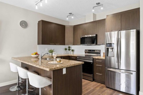121-300 Marina Drive, Chestermere, AB - Indoor Photo Showing Kitchen With Stainless Steel Kitchen