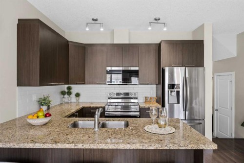 121-300 Marina Drive, Chestermere, AB - Indoor Photo Showing Kitchen With Stainless Steel Kitchen With Double Sink With Upgraded Kitchen