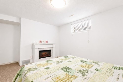821 Auburn Bay Boulevard Se, Calgary, AB - Indoor Photo Showing Bedroom With Fireplace