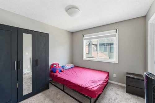 28 New Brighton Point Se, Calgary, AB - Indoor Photo Showing Bedroom