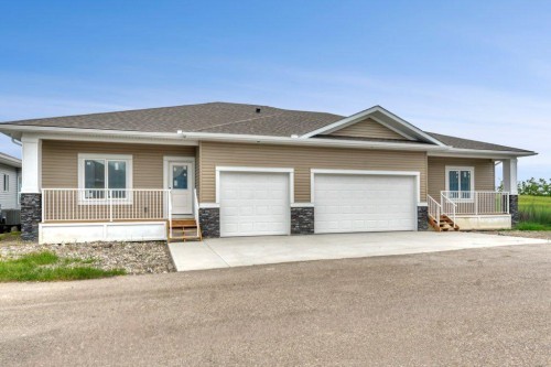 160 Ridgestone Lane, Diamond Valley, AB - Outdoor With Deck Patio Veranda With Facade