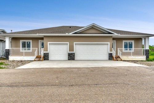 160 Ridgestone Lane, Diamond Valley, AB - Outdoor With Deck Patio Veranda With Facade