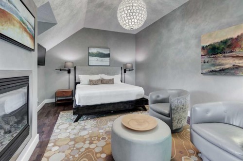 30 And 30G Victoria Cross Boulevard Sw, Calgary, AB - Indoor Photo Showing Bedroom With Fireplace
