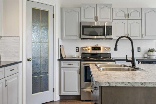 52 West Edge Road, Cochrane, AB - Indoor Photo Showing Kitchen With Stainless Steel Kitchen With Double Sink With Upgraded Kitchen