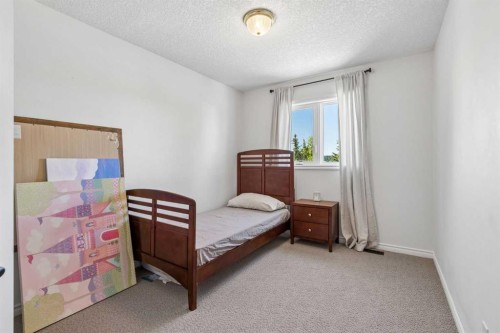 52 West Edge Road, Cochrane, AB - Indoor Photo Showing Bedroom