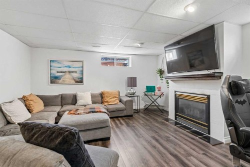 52 West Edge Road, Cochrane, AB - Indoor Photo Showing Living Room With Fireplace
