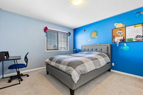 716 Boulder Creek Drive Se, Langdon, AB - Indoor Photo Showing Bedroom