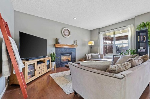 716 Boulder Creek Drive Se, Langdon, AB - Indoor Photo Showing Living Room With Fireplace
