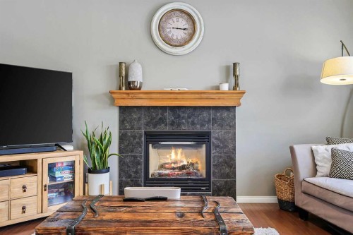 716 Boulder Creek Drive Se, Langdon, AB - Indoor Photo Showing Living Room With Fireplace