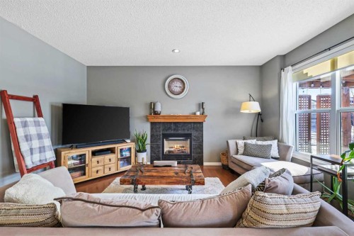 716 Boulder Creek Drive Se, Langdon, AB - Indoor Photo Showing Living Room With Fireplace