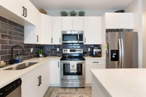 561 Canals Crossing Sw, Airdrie, AB - Indoor Photo Showing Kitchen With Double Sink