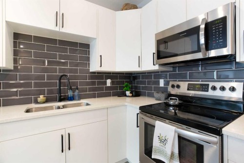 561 Canals Crossing Sw, Airdrie, AB - Indoor Photo Showing Kitchen With Double Sink