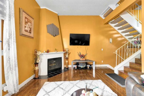 802-919 38 Street Ne, Calgary, AB - Indoor Photo Showing Living Room With Fireplace
