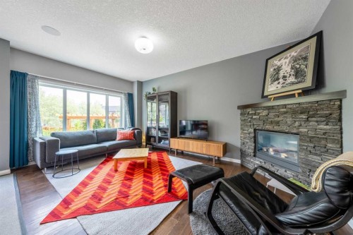 64 Sunrise Terrace, Cochrane, AB - Indoor Photo Showing Living Room With Fireplace