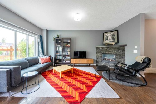 64 Sunrise Terrace, Cochrane, AB - Indoor Photo Showing Living Room With Fireplace