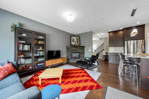 64 Sunrise Terrace, Cochrane, AB - Indoor Photo Showing Living Room With Fireplace