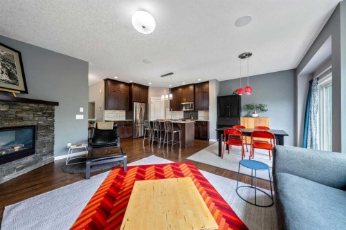 64 Sunrise Terrace, Cochrane, AB - Indoor Photo Showing Living Room With Fireplace