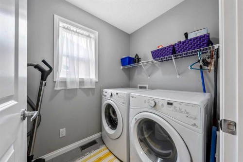 64 Sunrise Terrace, Cochrane, AB - Indoor Photo Showing Laundry Room