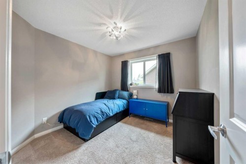64 Sunrise Terrace, Cochrane, AB - Indoor Photo Showing Bedroom