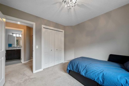 64 Sunrise Terrace, Cochrane, AB - Indoor Photo Showing Bedroom