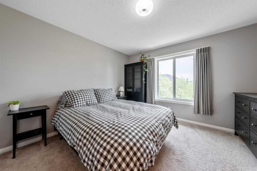 64 Sunrise Terrace, Cochrane, AB - Indoor Photo Showing Bedroom