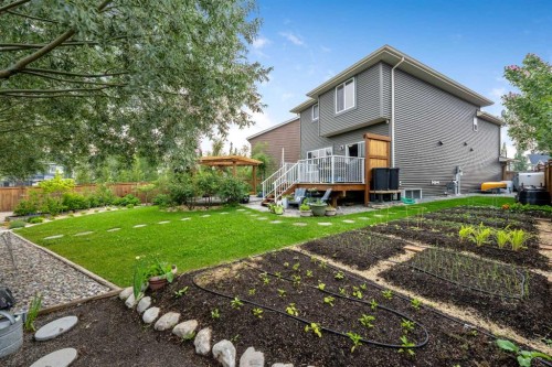 64 Sunrise Terrace, Cochrane, AB - Outdoor With Backyard