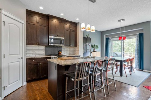 64 Sunrise Terrace, Cochrane, AB - Indoor Photo Showing Kitchen With Upgraded Kitchen