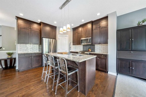 64 Sunrise Terrace, Cochrane, AB - Indoor Photo Showing Kitchen With Upgraded Kitchen