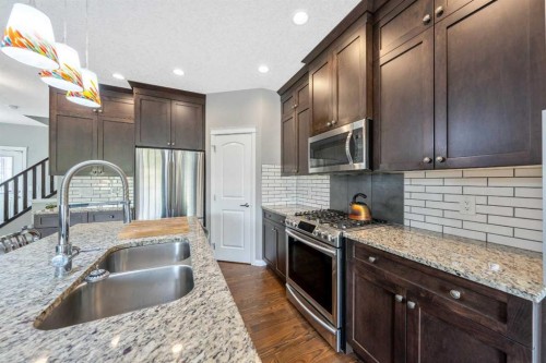 64 Sunrise Terrace, Cochrane, AB - Indoor Photo Showing Kitchen With Double Sink With Upgraded Kitchen