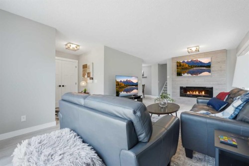 55 Sunbank Road Se, Calgary, AB - Indoor Photo Showing Living Room With Fireplace