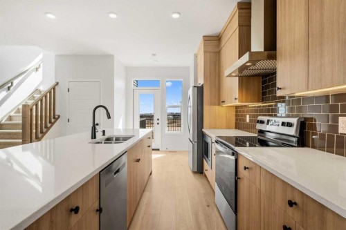 659 Chelsea Pier Run, Chestermere, AB - Indoor Photo Showing Kitchen With Double Sink With Upgraded Kitchen
