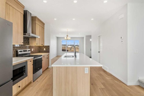 659 Chelsea Pier Run, Chestermere, AB - Indoor Photo Showing Kitchen With Double Sink With Upgraded Kitchen