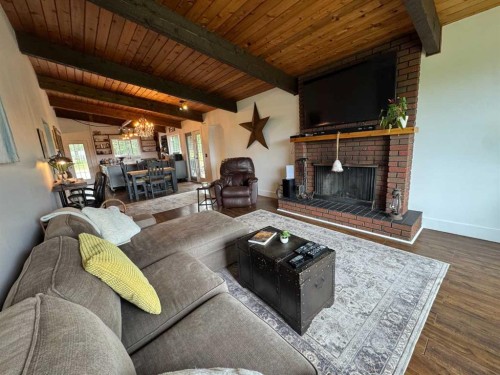 33374 Range Road 55, Rural Mountain View County, AB - Indoor Photo Showing Living Room With Fireplace