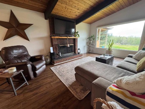 33374 Range Road 55, Rural Mountain View County, AB - Indoor Photo Showing Living Room With Fireplace