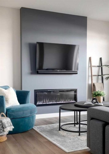 79 Waterford Mews, Chestermere, AB - Indoor Photo Showing Living Room With Fireplace