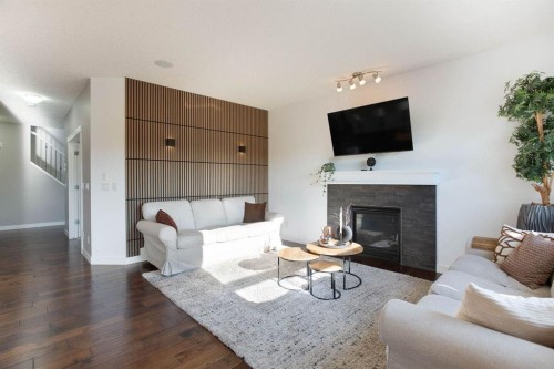 213 Kingsmere Cove Se, Airdrie, AB - Indoor Photo Showing Living Room With Fireplace
