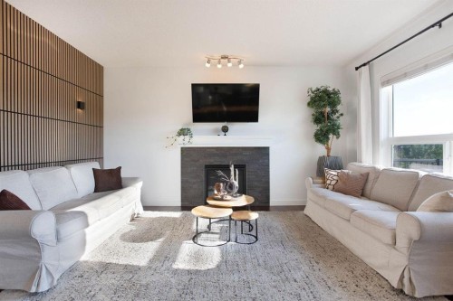 213 Kingsmere Cove Se, Airdrie, AB - Indoor Photo Showing Living Room With Fireplace