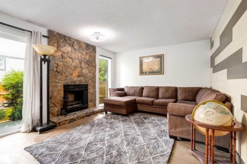 112-1190 Ranchview Road Nw, Calgary, AB - Indoor Photo Showing Living Room With Fireplace