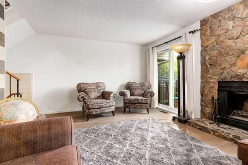 112-1190 Ranchview Road Nw, Calgary, AB - Indoor Photo Showing Living Room With Fireplace