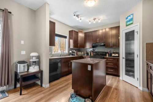 116 Drake Landing Loop, Okotoks, AB - Indoor Photo Showing Kitchen With Double Sink With Upgraded Kitchen