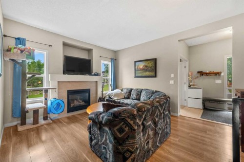 116 Drake Landing Loop, Okotoks, AB - Indoor Photo Showing Living Room With Fireplace