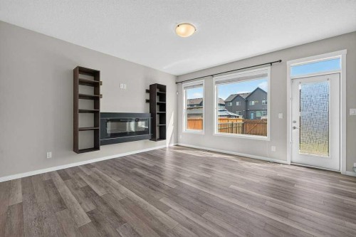 556 Belmont Heath Sw, Calgary, AB - Indoor Photo Showing Living Room With Fireplace
