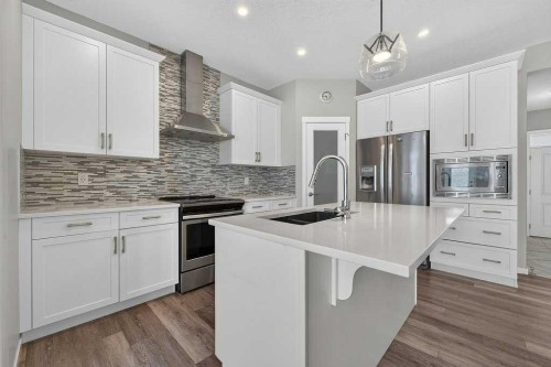 556 Belmont Heath Sw, Calgary, AB - Indoor Photo Showing Kitchen With Stainless Steel Kitchen With Double Sink With Upgraded Kitchen
