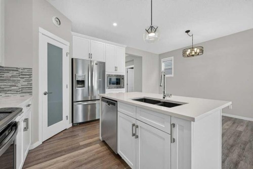 556 Belmont Heath Sw, Calgary, AB - Indoor Photo Showing Kitchen With Stainless Steel Kitchen With Double Sink With Upgraded Kitchen